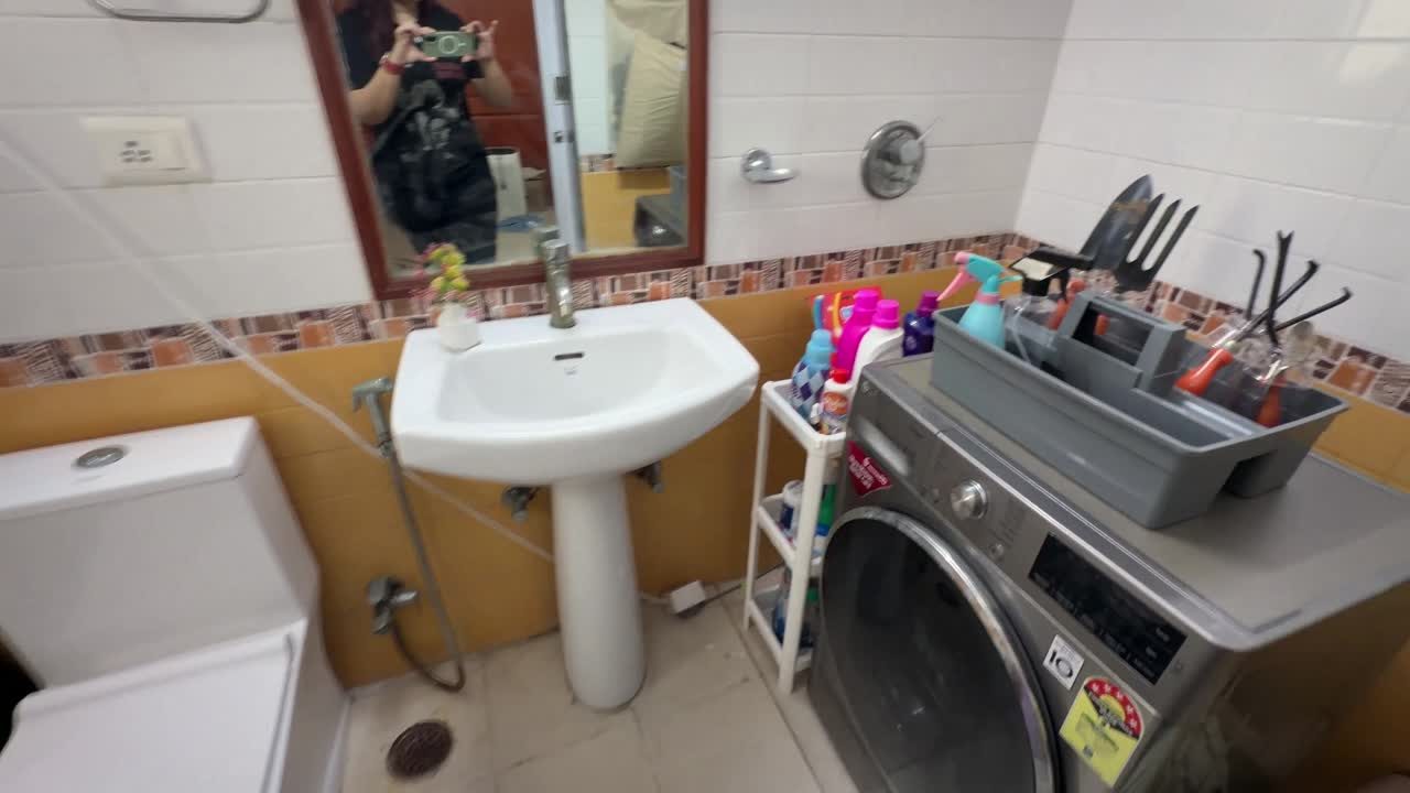 Small utility bathroom laundry room after decluttering, with an open floor and organized supplies