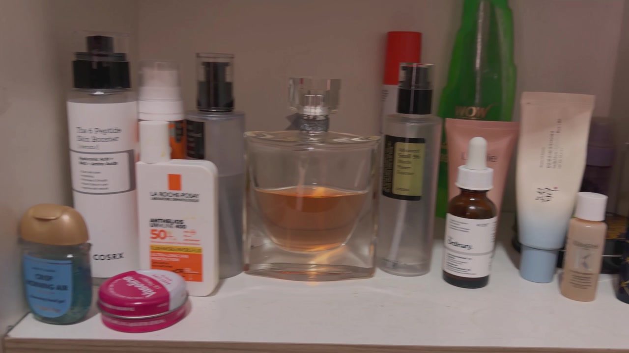 Everyday toiletries visible in the cabinet after empty and unwanted bottles were removed.