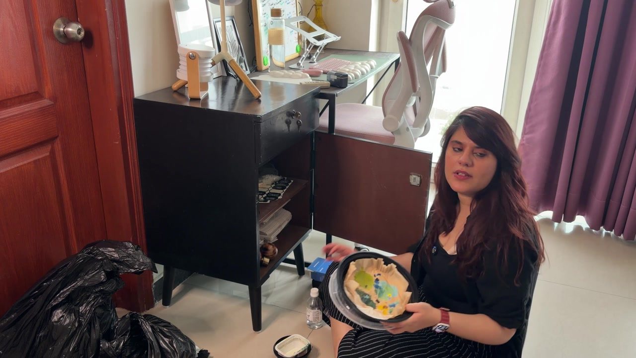 Aastha checks her study cabinet for obvious rubbish while leaving meaningful art supplies alone.
